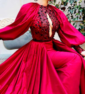 A lavish red keyhole-style gown with gemstone embroidery.