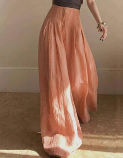 Baggy linen trousers in peach tones.