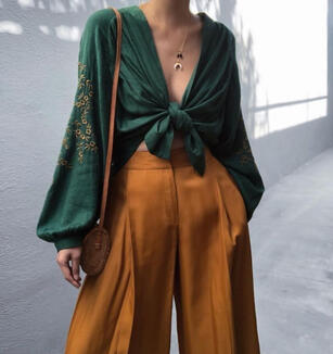 An ensemble in rich orange and green