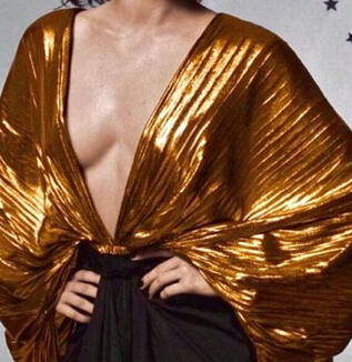 A gold blouse with a deep V neckline