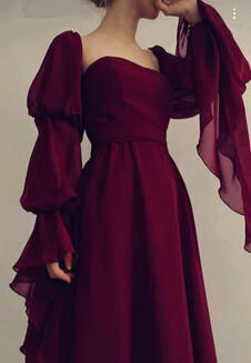 A wine-red chiffon gown with trailing sleeves